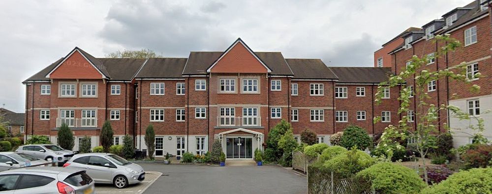 Exterior of Swift House McCarthy Stone retirement living building with parking