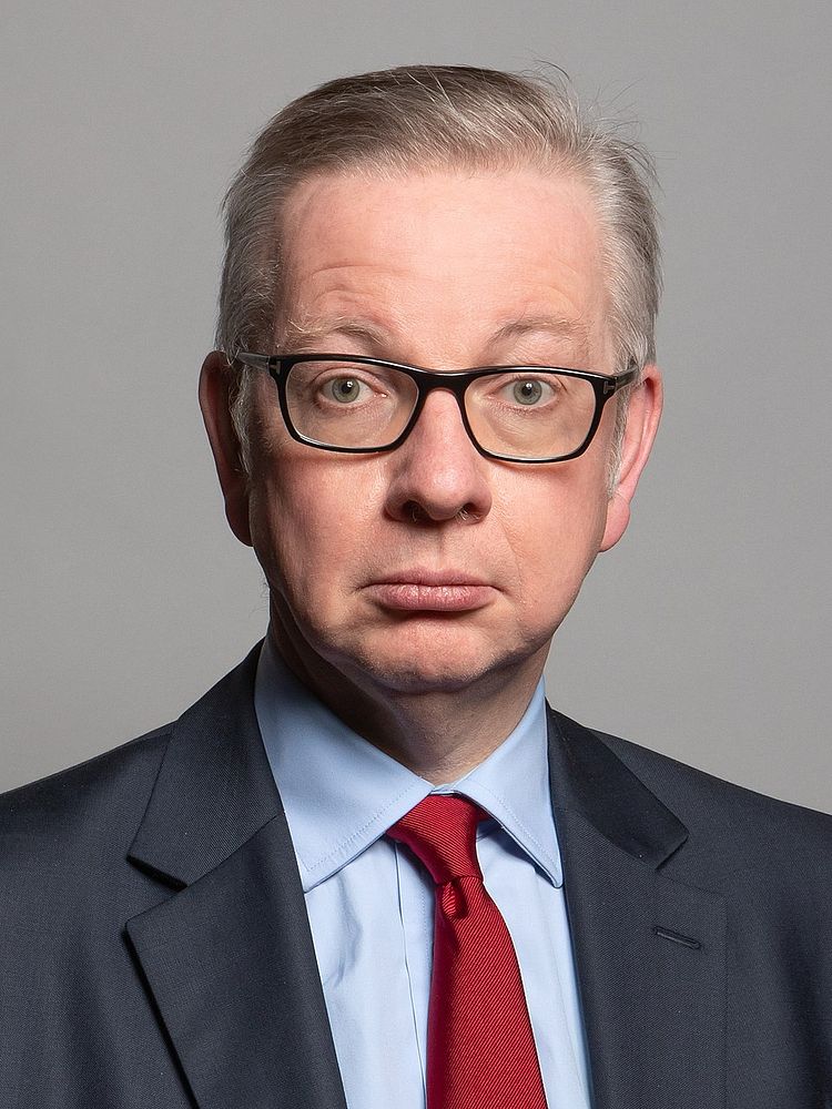 Portrait of a middle-aged man in glasses, suit and red tie