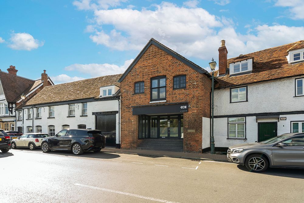 Street view of retirement property building with parked cars outside